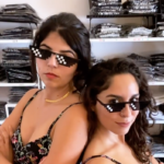 Camila and Rita leaning against each other with pixel glasses